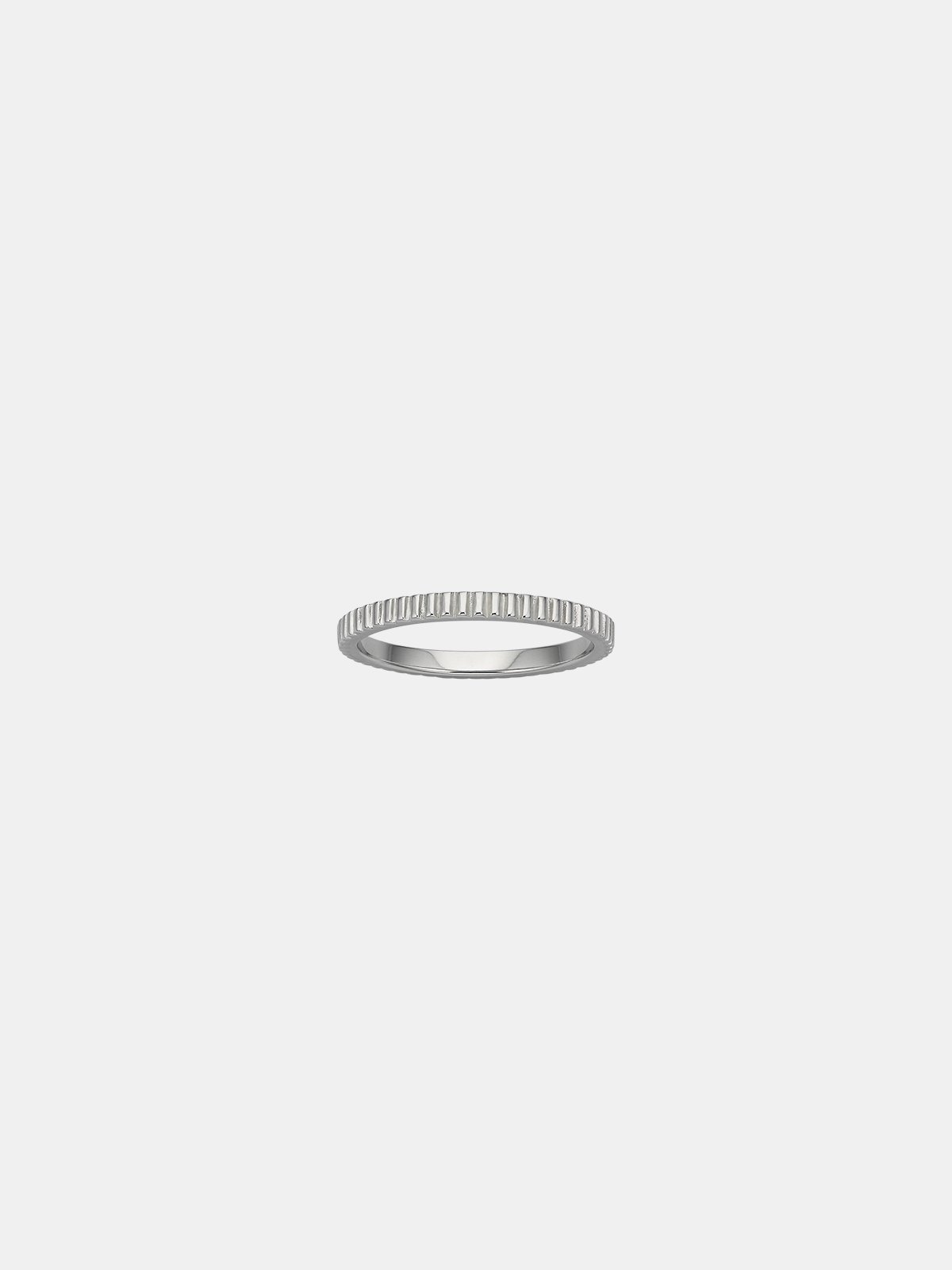 Silver ring with a textured band on a light gray background