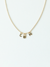 Solid gold mix it up necklace on cable chain with three small pendants on a white background