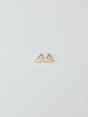 Solid gold dotty love heart-shaped stud earrings on a light gray background