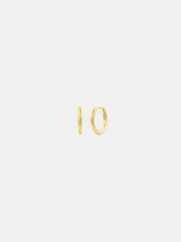 Gold hoop earrings on a light gray background