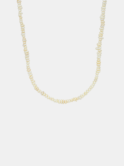 Pearl necklace on a light gray background