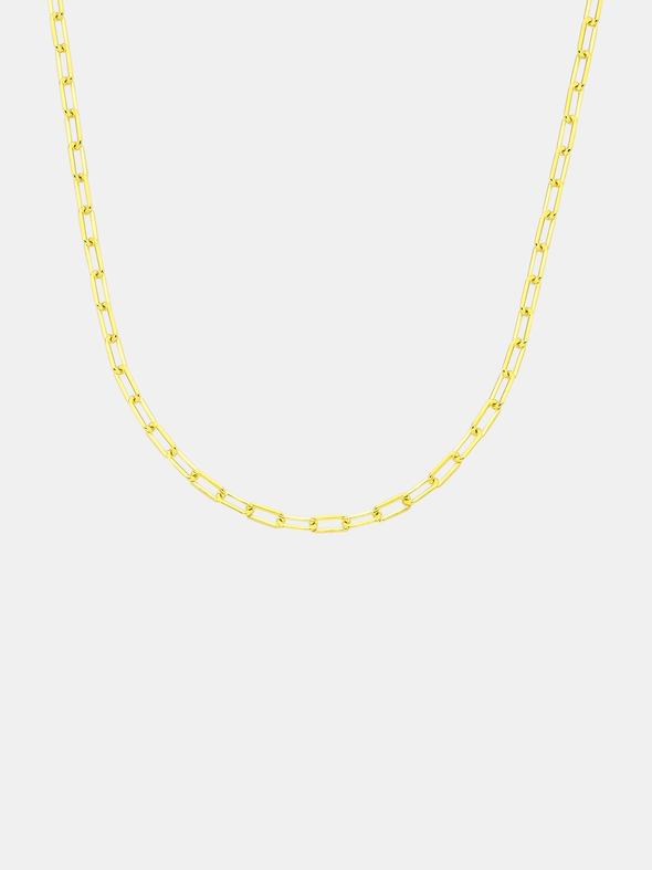 Gold chain necklace on a light gray background