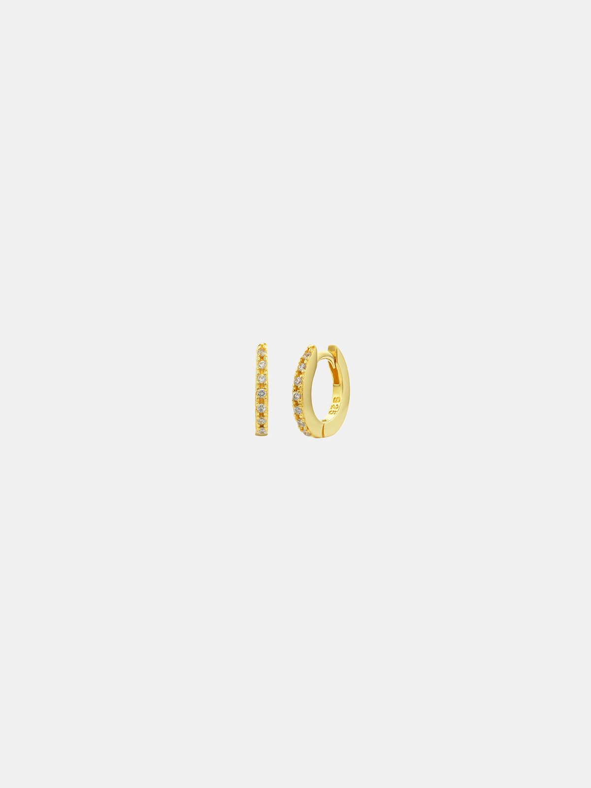 Gold hoop earrings on a light gray background