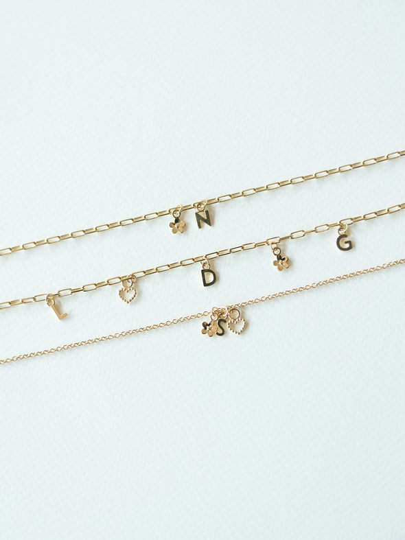 Mix It Up solid gold charm bracelets on a variety of chains