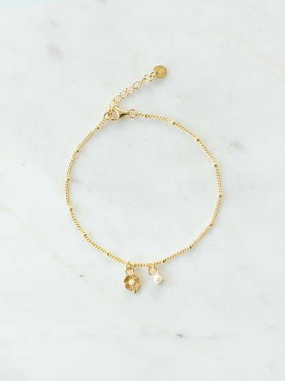Gold Mix It Up bracelet on satellite chain with two charms on a light gray background