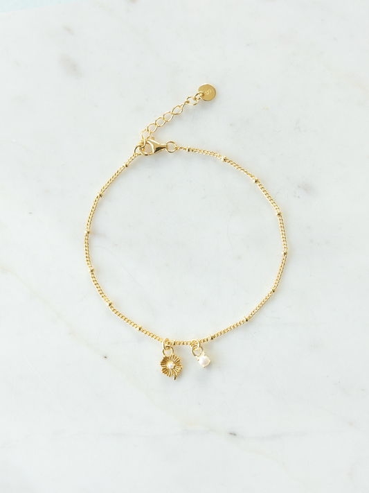 Gold Mix It Up bracelet on satellite chain with two charms on a light gray background