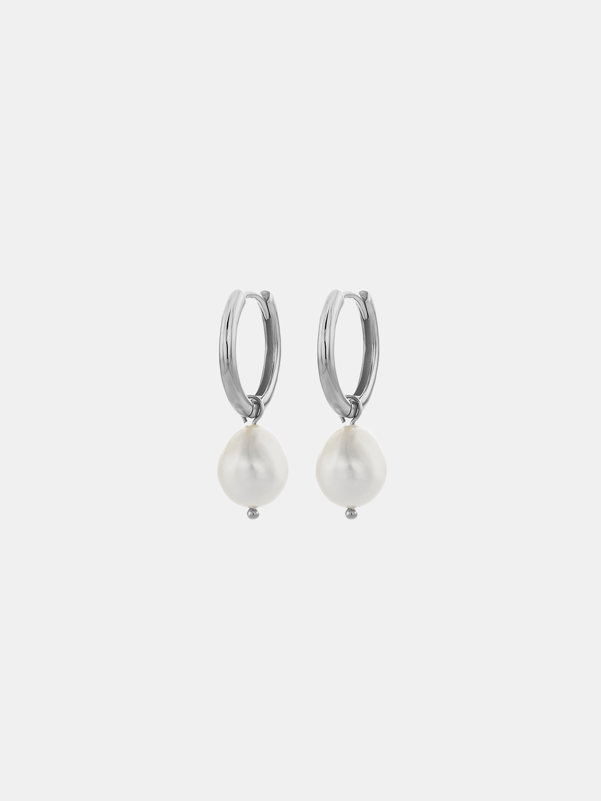 Pair of pearl hoop earrings on a light gray background