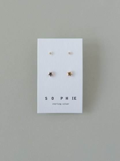 Set of star-shaped earrings on a 'Sophie' branded card against a gray background