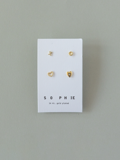 Set of gold earrings on a 'SOPHIE' branded card against a gray background