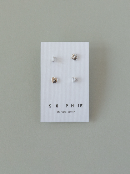 Set of four silver earrings on a 'Sophie' branded card against a gray background