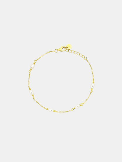 Gold bracelet on a light gray background