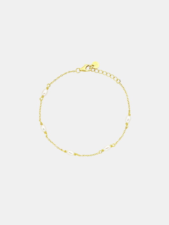 Gold bracelet on a light gray background