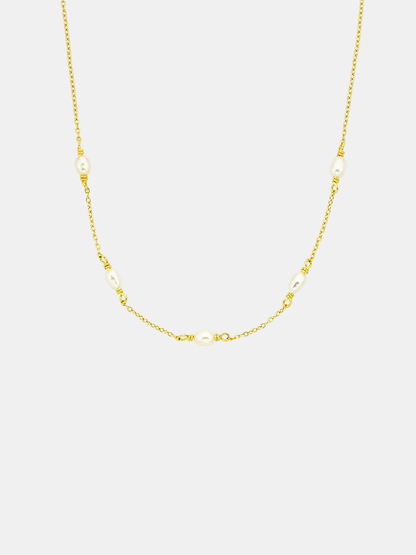 Gold chain pearl necklace on a white background