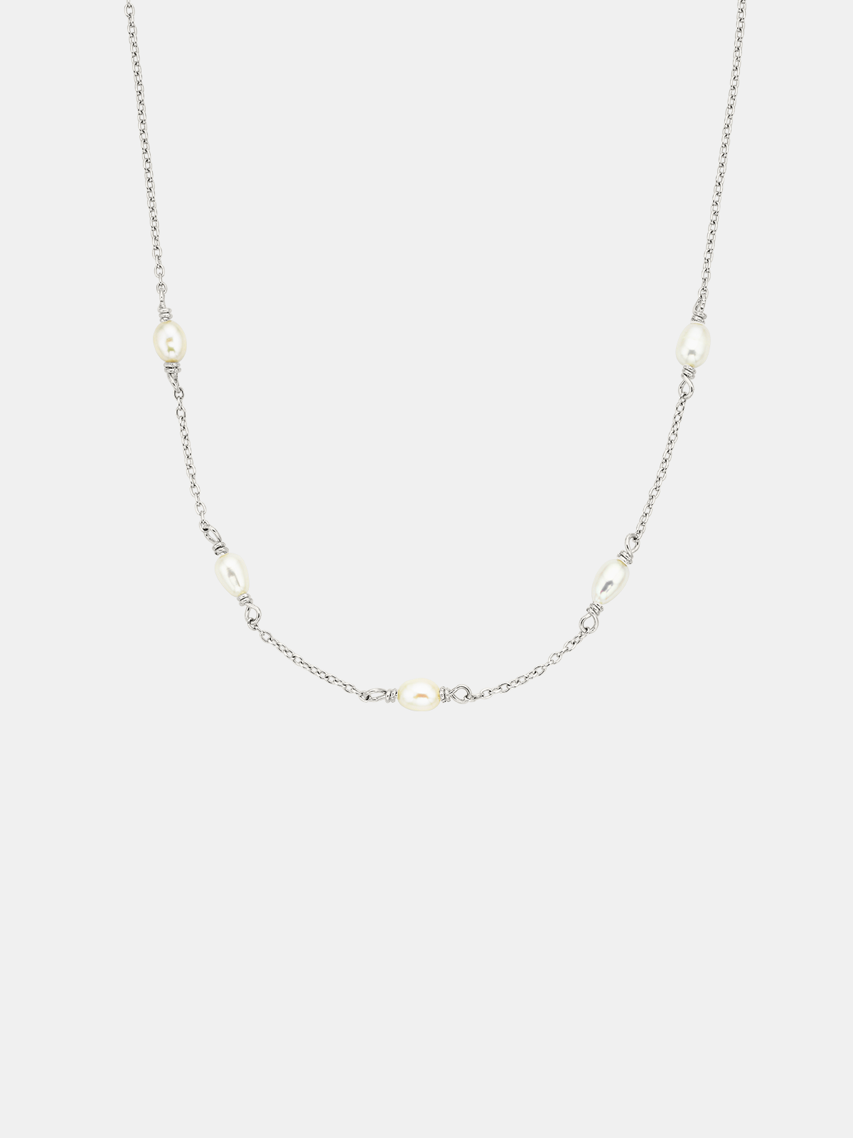 Necklace with small pearls on a light gray background