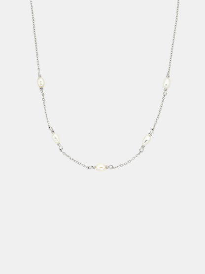 Necklace with small pearls on a light gray background