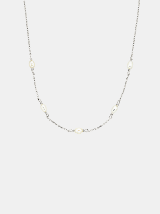 Necklace with small pearls on a light gray background