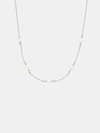 Necklace with small pearls on a light gray background