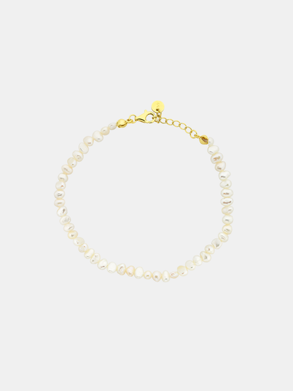 Pearl anklet with gold clasp on a white background