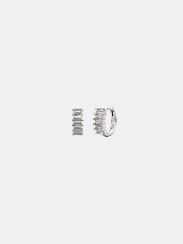 Pair of silver hoop earrings with rocks on a light gray background