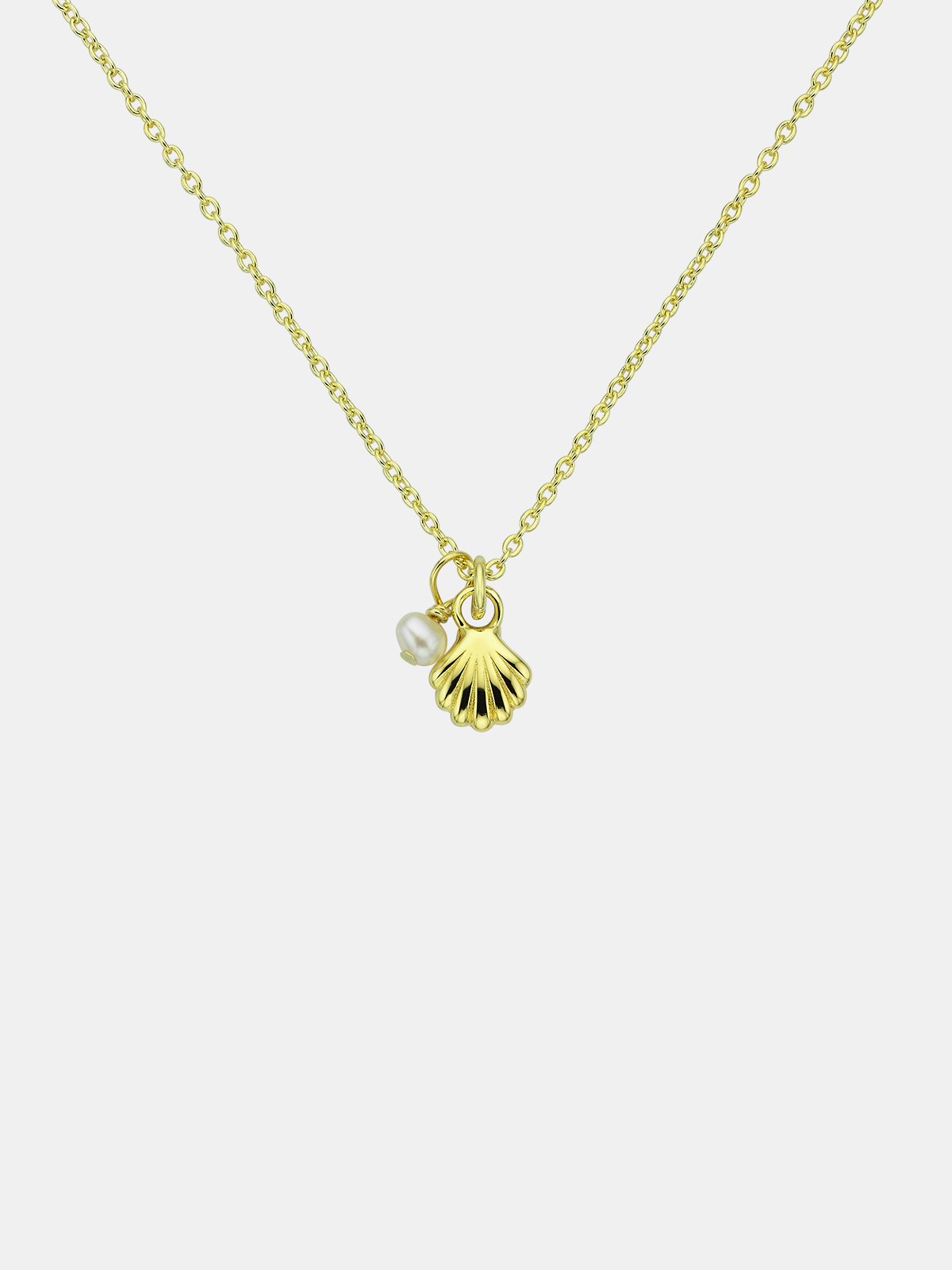 Gold necklace with shell and pearl charm on a white background