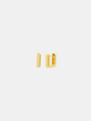 Gold hoop earrings on a light beige background