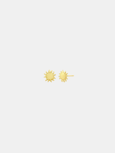 Gold sun-shaped earrings on a light gray background