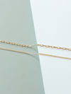 Mini links (top) and cable (bottom) chains on a light green and white background