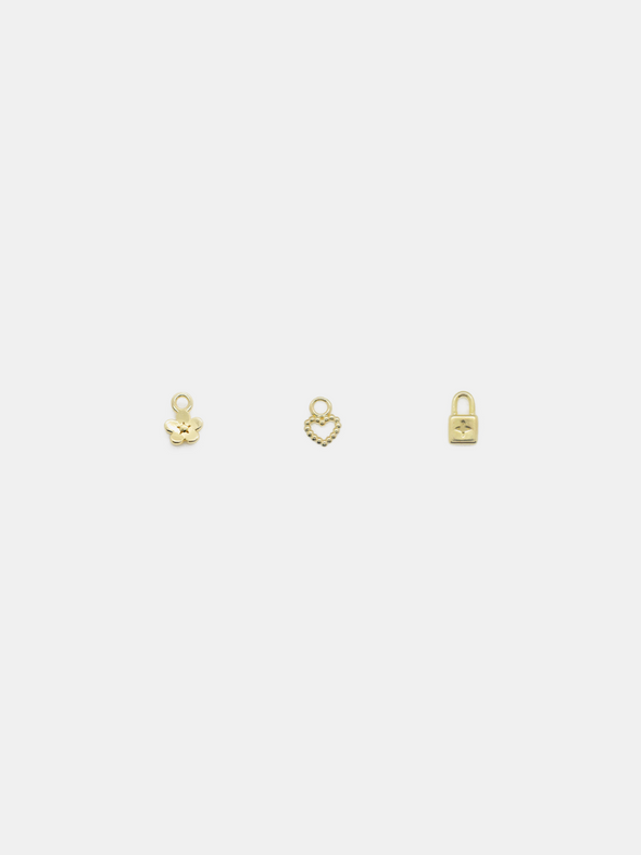 Daisy Day, Dotty Love & Little Lock Solid Gold pendants on a light grey background
