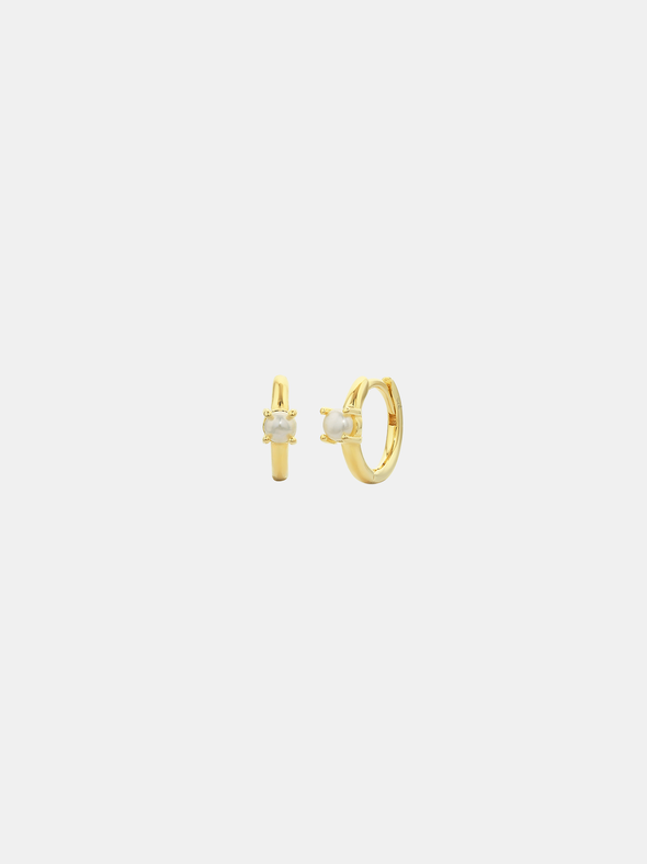 Gold hoop earrings with small round stones on a light gray background