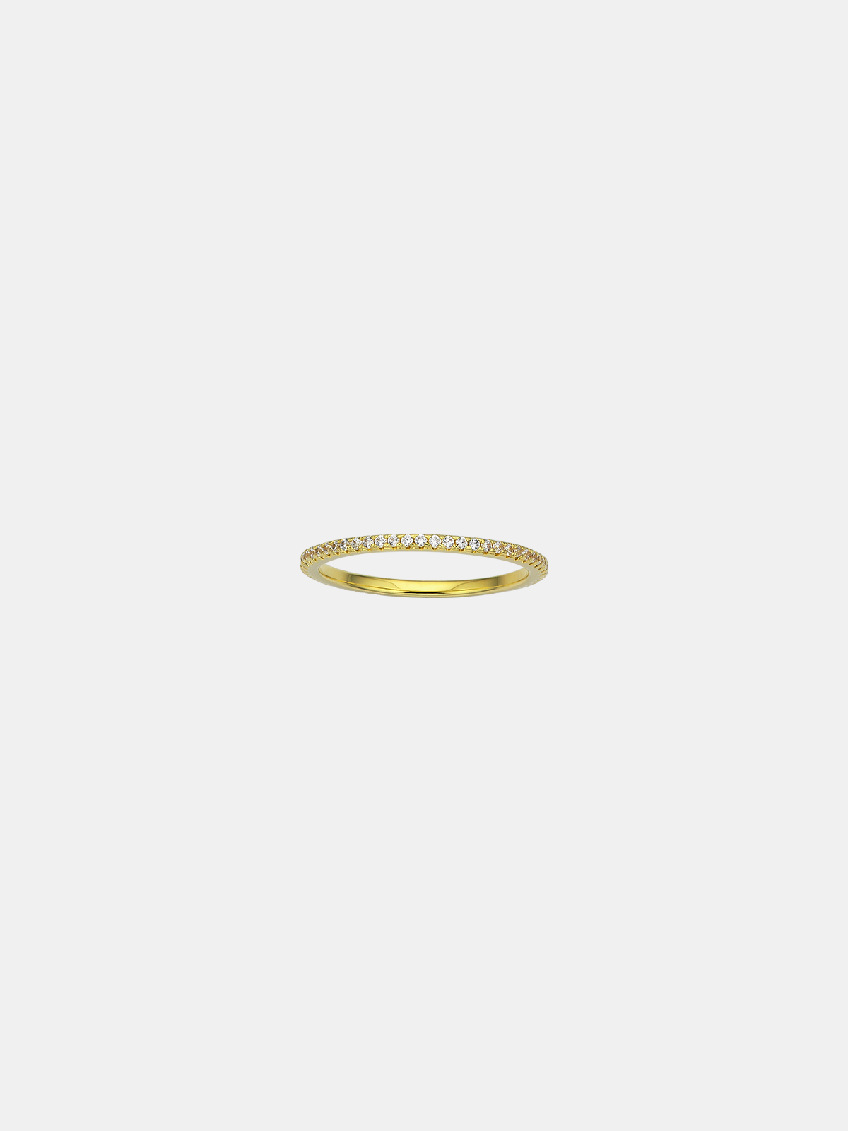 Gold ring with small CZ stones on a light gray background