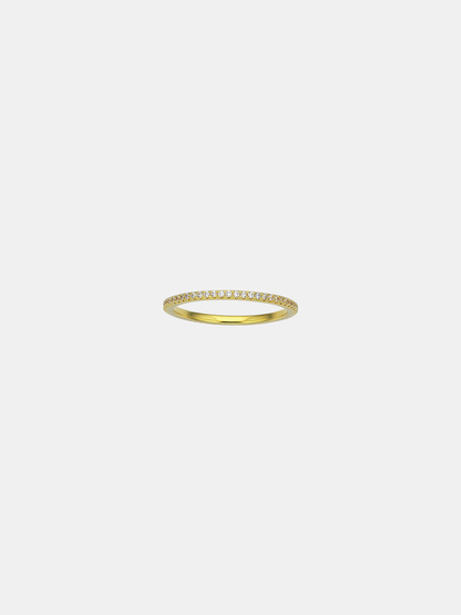 Gold ring with small CZ stones on a light gray background