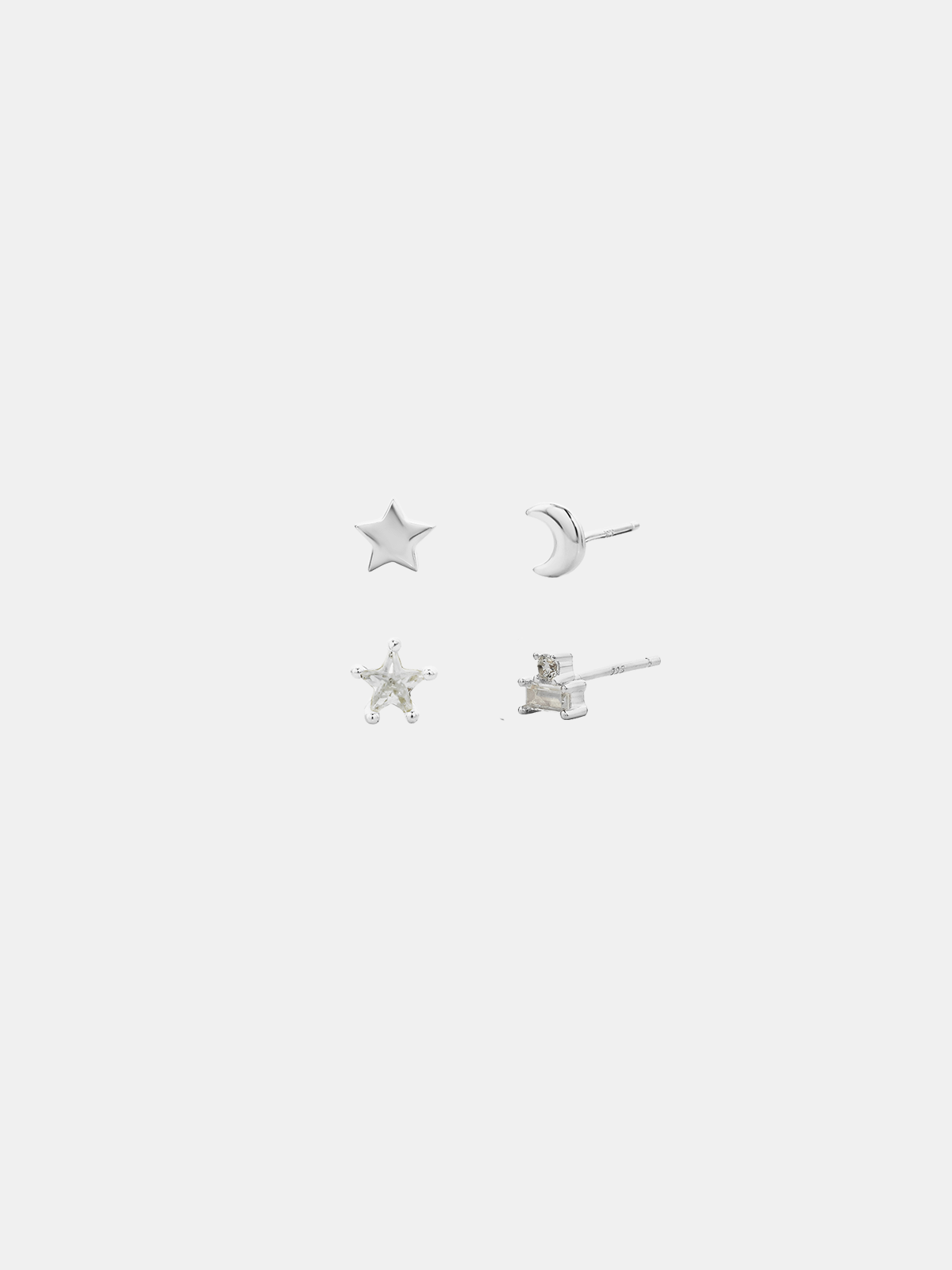 Set of silver star-shaped earrings on a white background