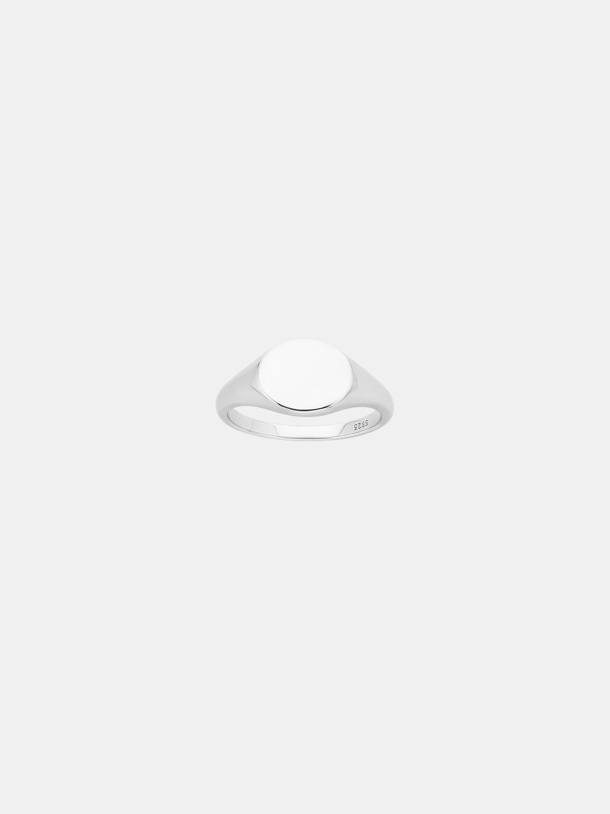Silver signet ring on a light gray background