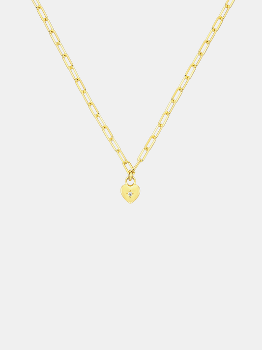 Gold necklace with a small sweetheart pendant on a light gray background