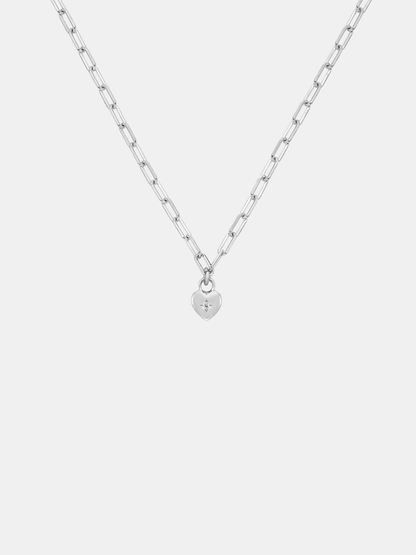 Silver necklace with a small sweetheart pendant on a light gray background