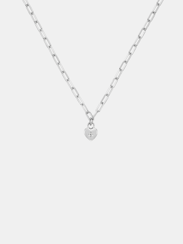 Silver necklace with a small sweetheart pendant on a light gray background