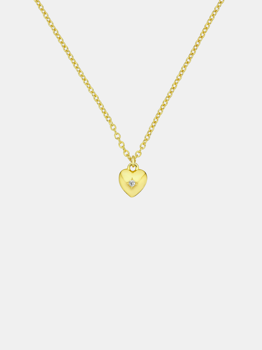 Gold heart-shaped pendant necklace on a light gray background