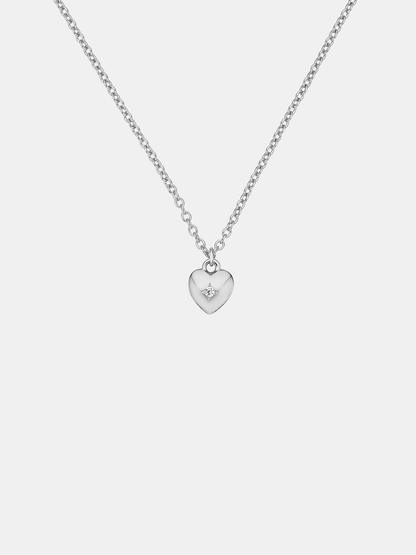 Silver heart-shaped pendant necklace on a light gray background
