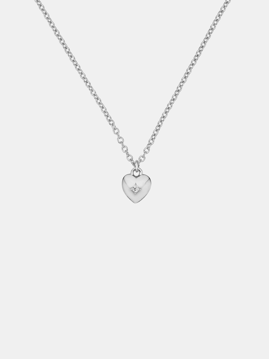 Silver heart-shaped pendant necklace on a light gray background