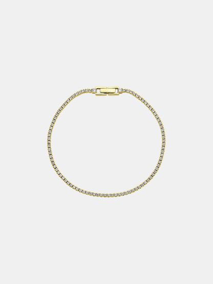 Gold bracelet with zircons on a light gray background