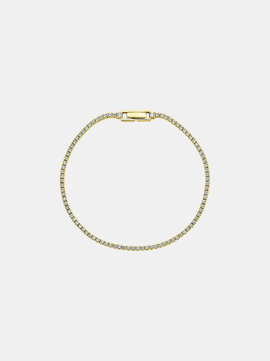 Gold bracelet with zircons on a light gray background