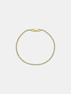 Gold bracelet with zircons on a light gray background