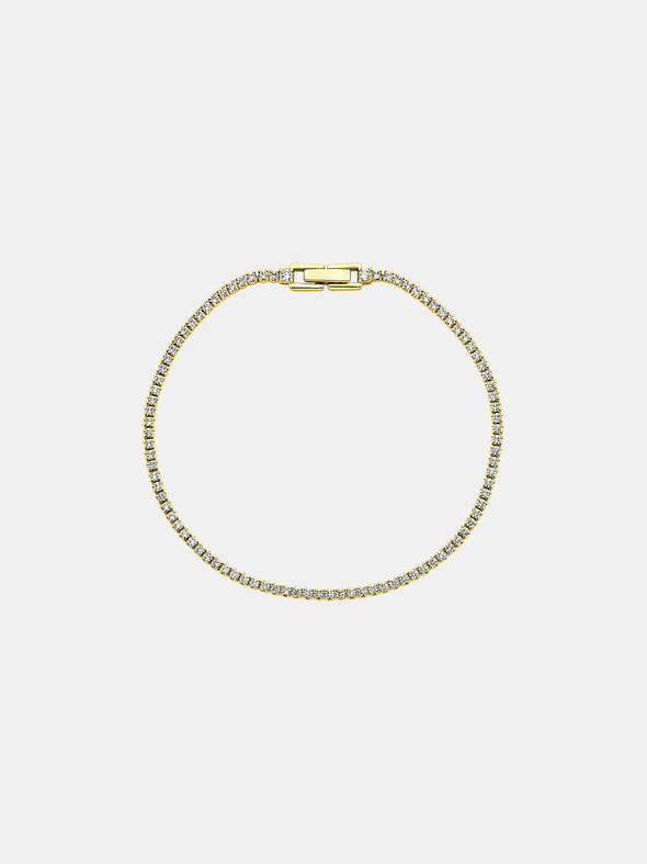 Gold bracelet with zircons on a light gray background