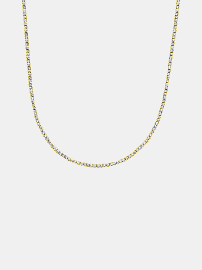 Gold tennis chain necklace on a light gray background