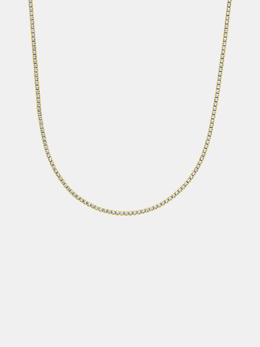Gold tennis chain necklace on a light gray background