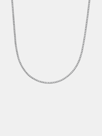 Silver tennis chain necklace on a light gray background
