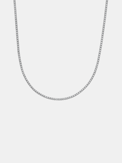 Silver tennis chain necklace on a light gray background