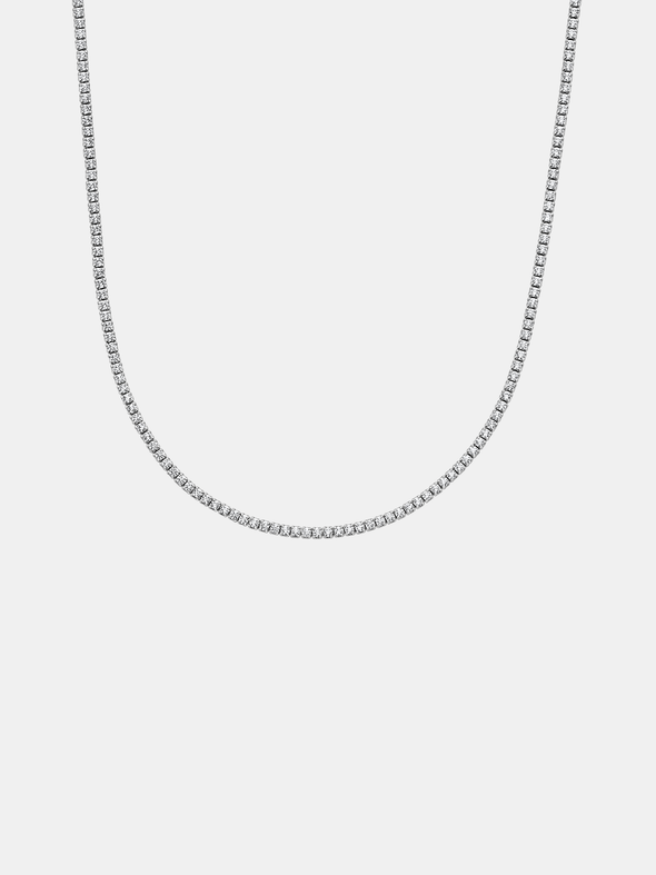 Silver tennis chain necklace on a light gray background
