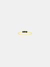 Gold ring with three black stones on a white background