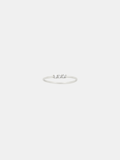 Silver ring with small stones on a light gray background
